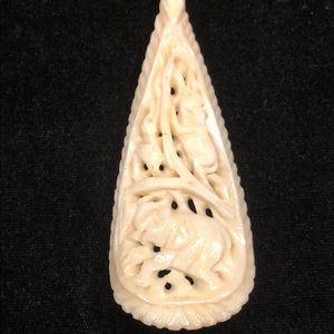 Fake ivory necklace with beads and carvings.